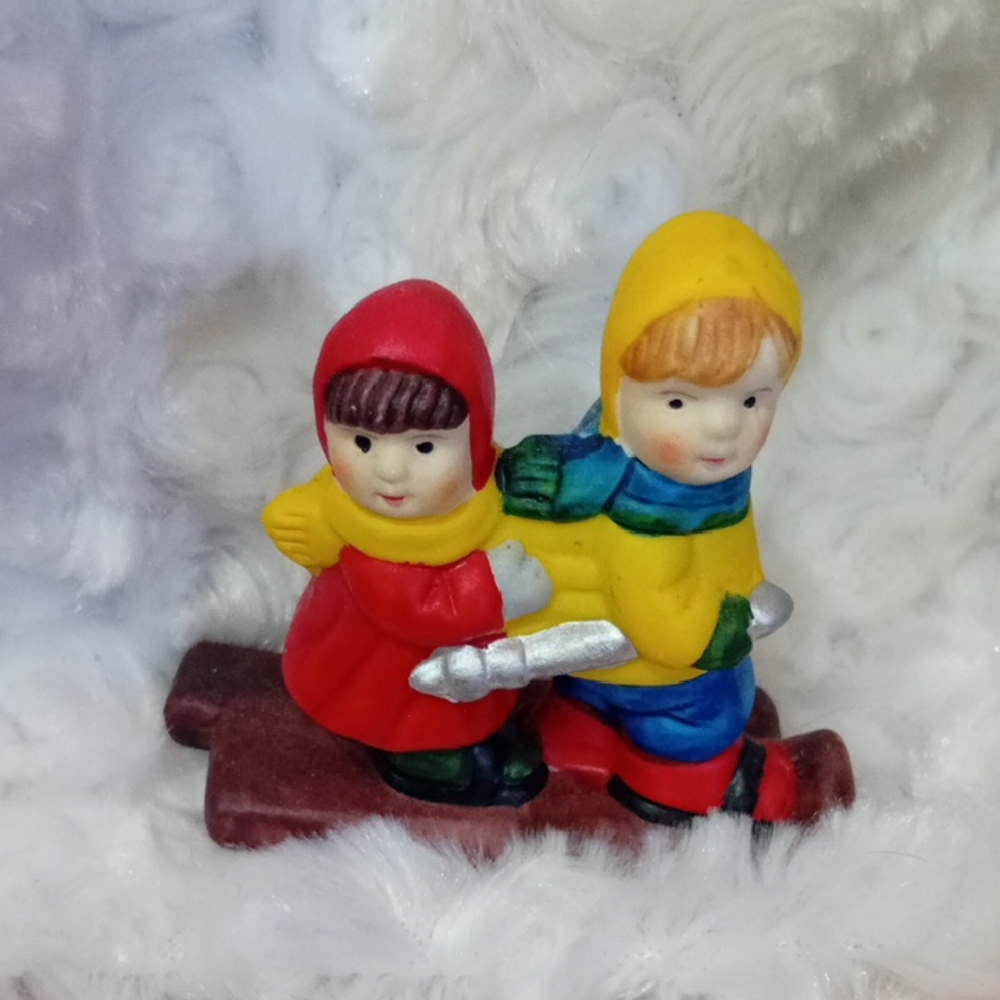 Adorable Kids Sledding Figurine with Red and Yellow Outfits